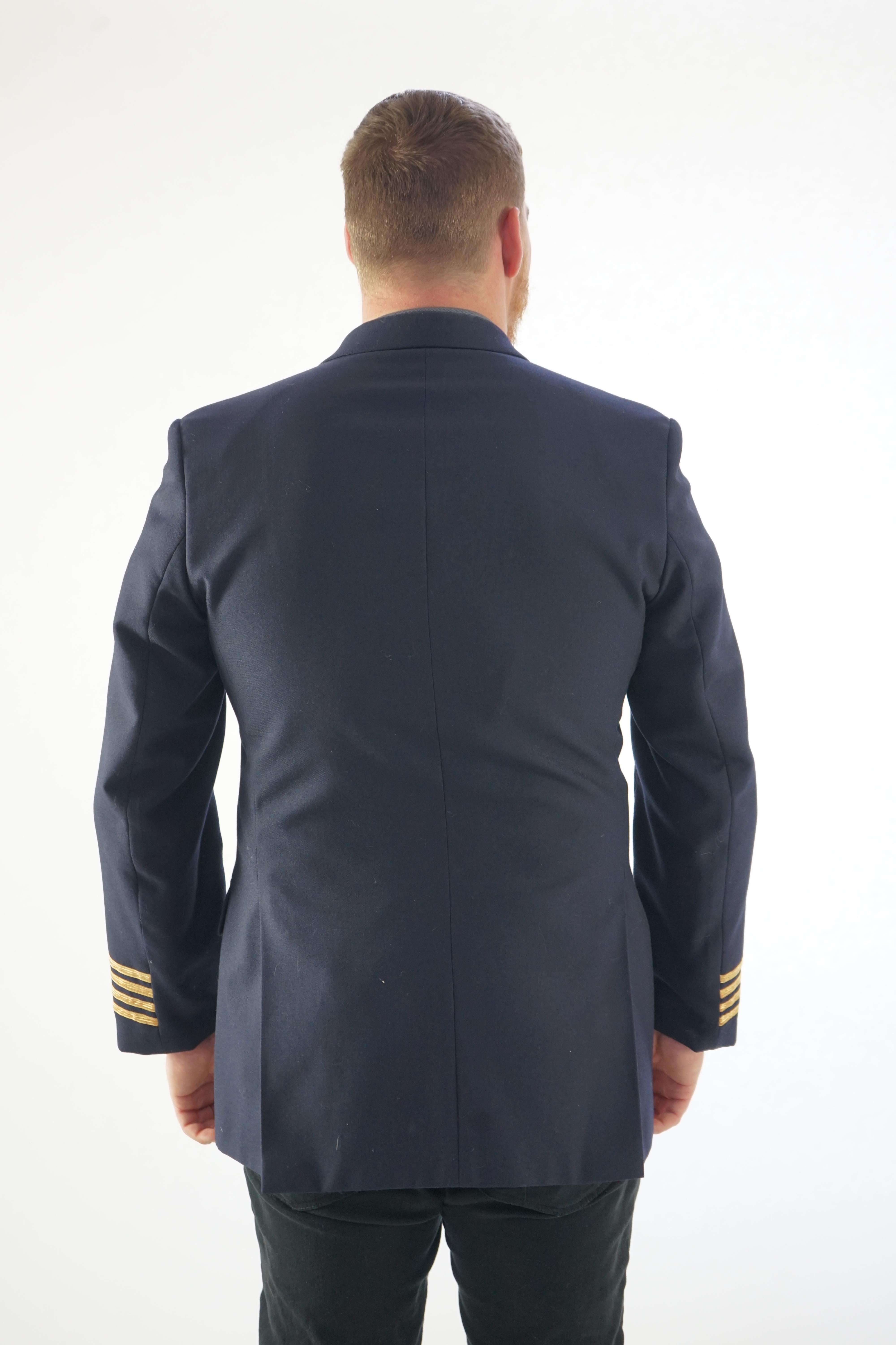 A modern naval style black-navy uniform jacket with gold trim.